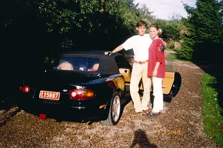 The black Mazda MX from the year 1991 as the two young Koenigseggs are standing beside the car.