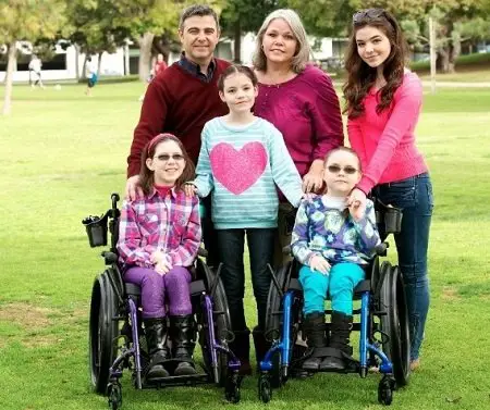The McLaughlin family pictures. Two of her three sisters suffering from a rare disease sitting in the front on wheelchairs. Her Parents to her right.