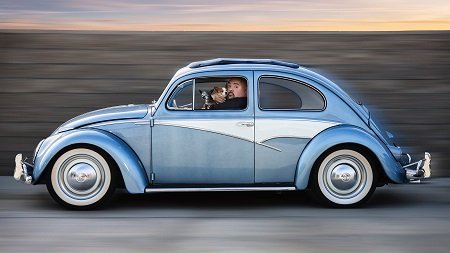 Gabriel Iglesias in his Volkswagen Bug with his dog..