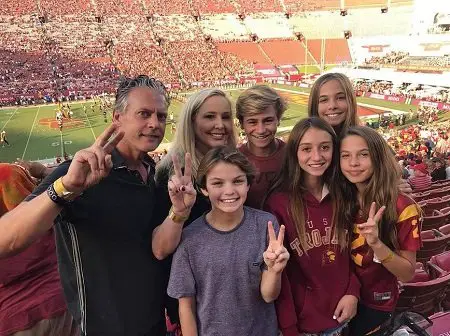 Shannon Beador, David Beador and their daughters with a boy guest peace sign and smiling while watching watching USC play football dated October 14.