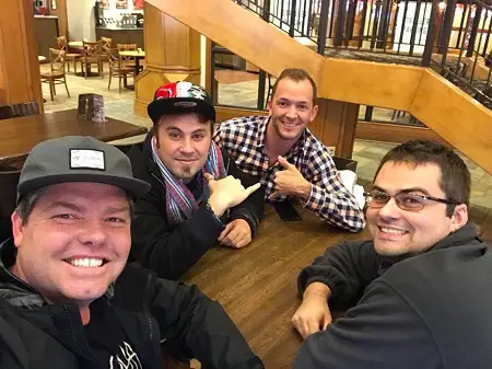 Trevor Chapman and his crew in a table with one taking the selfie.