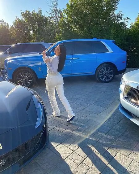 Kylie Jenner dancing around her cars.