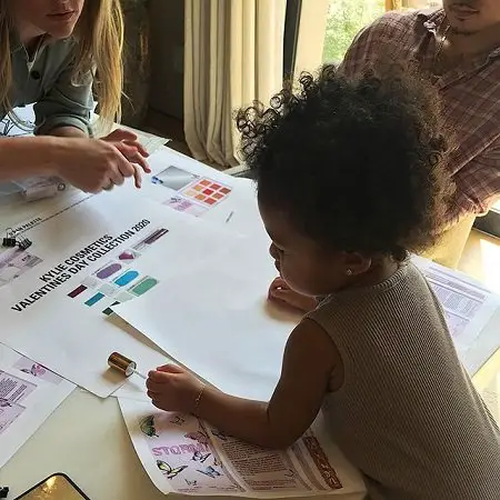 Stormi looking at sheet for the Valentine's Day collection.