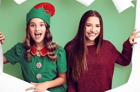 Annie LeBlanc and Maddie Ziegler ripping the poster for 'Holiday Spectacular'.