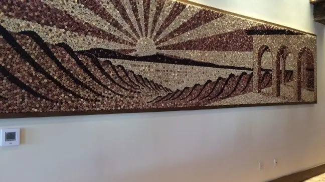 A sunset mural made up of corks as mentioned in the paragraph.