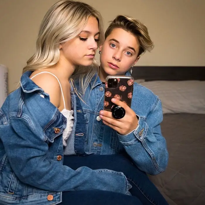 Wallpaper: Girlfriend Coco Quinn sitting on Gavin Magnus' lap sideways as he takes a mirror selfie.