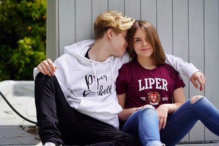 Piper Rockelle wearing a 'Liper' shirt and Lev Cameron wearing a Piper Rockelle hoodie being romantic.