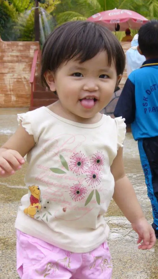 Faline San as a child sticking her tongue out.