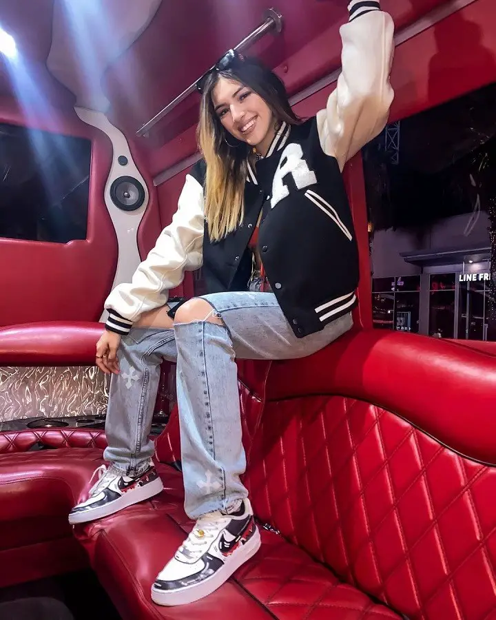 Ahlyssa Marie inside a party bus sitting on top of the red couch.