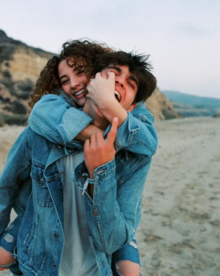 Sofie Dossi grappling boyfriend Dom Brack's face from behind.