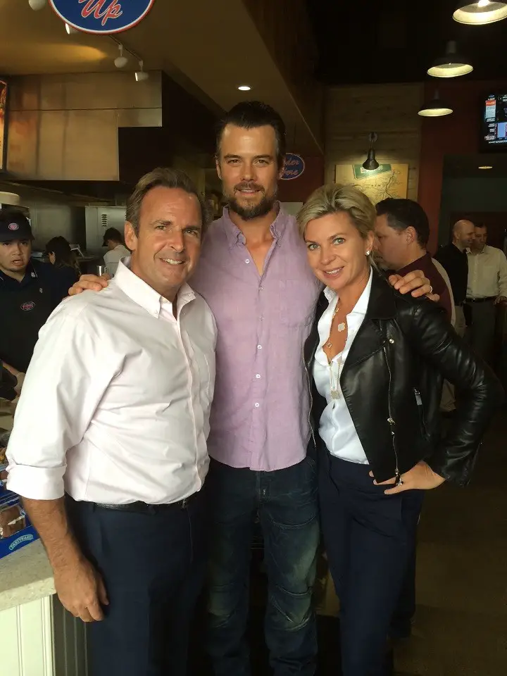 Peter Cancro (left), his wife Tatiana Cancro (right) with Josh Duhamel (center) at a Jersey Mike's store.