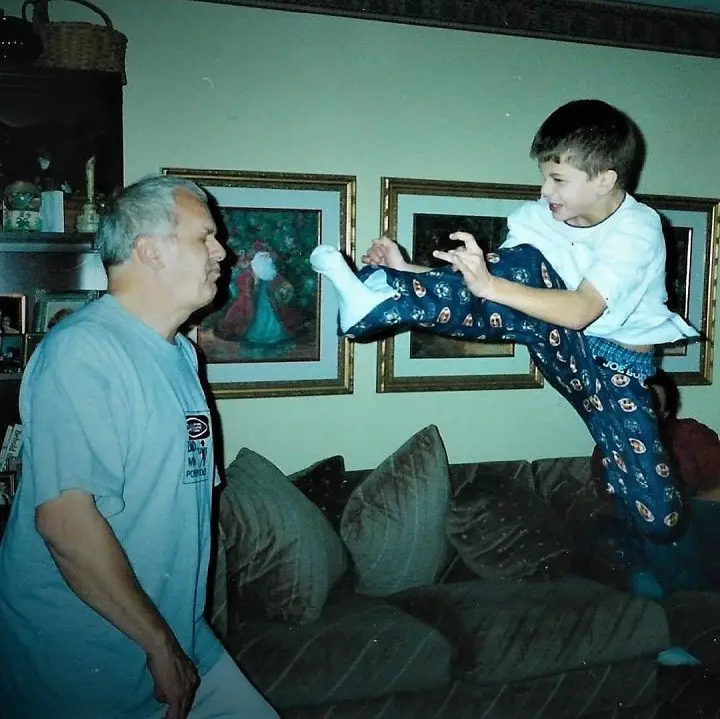 A young Barrett Carnahan (right) swinging a kick at his dad in a vintage photo.