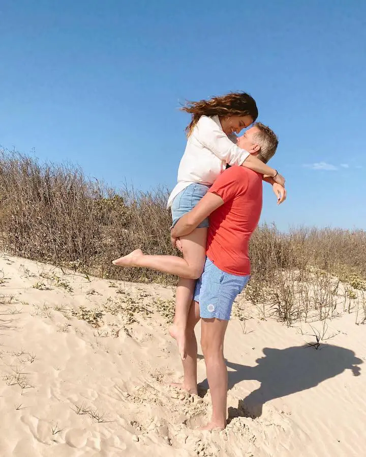 Mindy McKnight (left) being carried by her husband Shaun McKnight (right) for a romantic pose with her pointed toe.