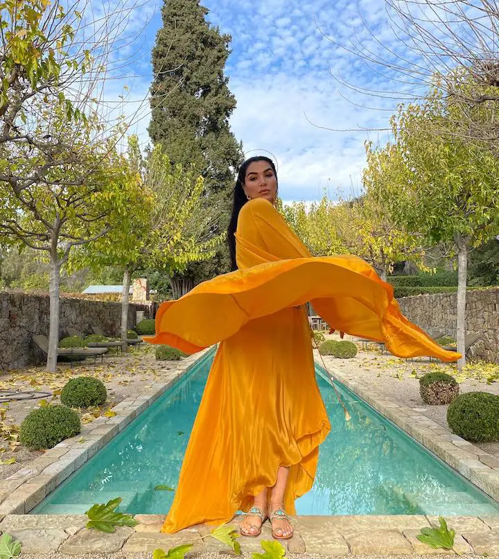 Asa Soltan Rahmati flaunting her yellow dress from her own clothing line, Asa Kaftans.