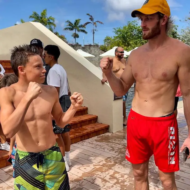 Ashton Myler (left) posing as a boxer while in boxers in front of Logan Paul (right) approaching for a fist bump.