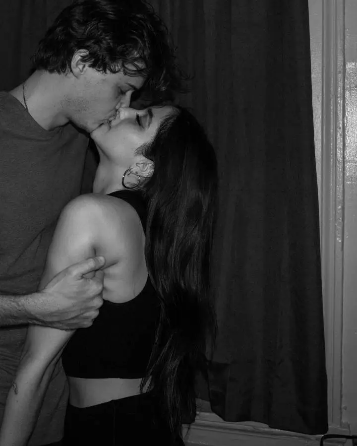 Christopher Briney kissing his girlfriend, Isabel Machado.