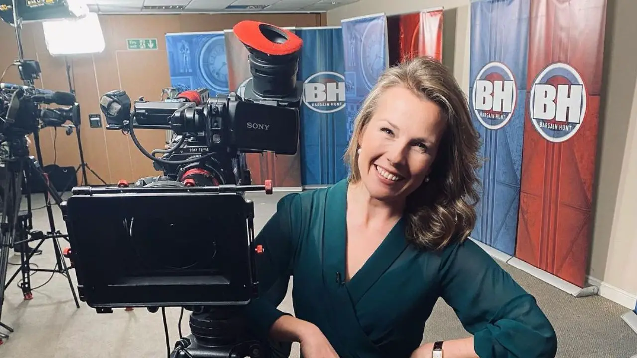 Christina Trevanion posing behind the camera on the sets of Bargain Hunt.