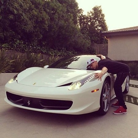 Rob Dyrdek hugging his white Ferrari 458 Italia.