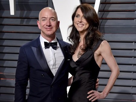 Jeff in a suit and bow tie and MacKenzie in a black dress, both smiling for the camers.