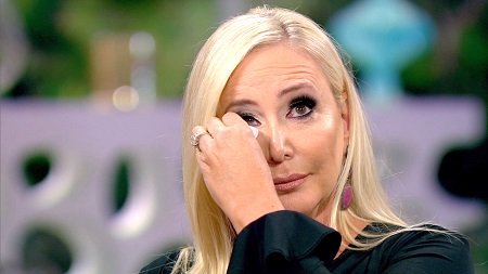 Shannon Beador rubbing the tears off her face.