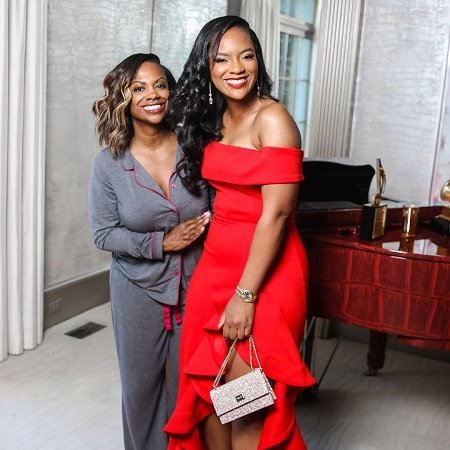 Kandi Burruss with her teenage daughter RIley in a red dress for her prom.