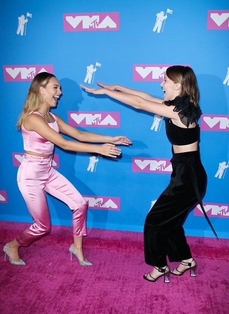 Maddie Ziegler and Millie Bobby Brown in an about-to-hug pose.