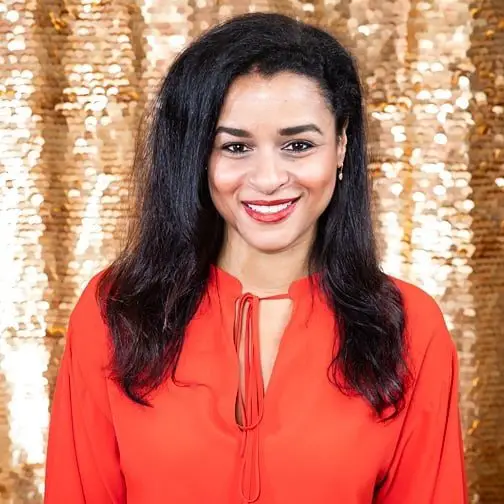 Sarah Cooper smiling in a red top.