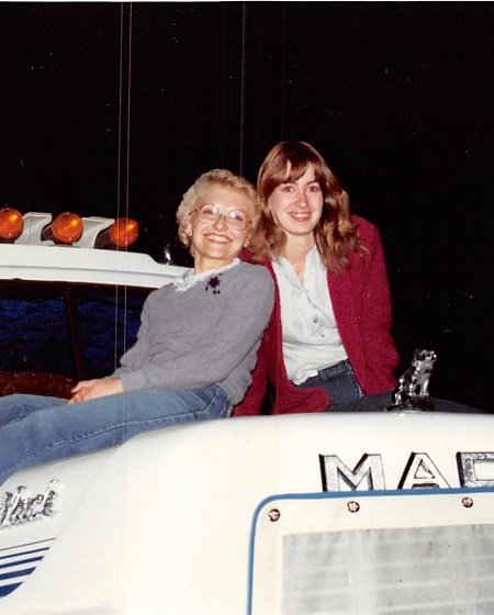 Julie Nolke's relative with her mom Cheryl Nolke on the hood of a semi-truck.