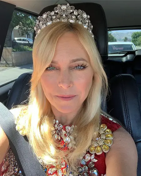 Sutton Stracke taking a selfie with her Tiara and the custom Couture, from Dolce & Gabbana, in her car.