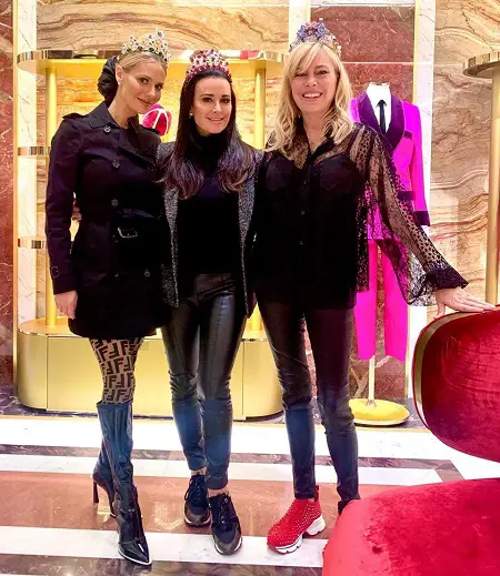 Dorit Kemsley, Kyle Richards and Sutton Stracke posing in black clothes and triaras on.