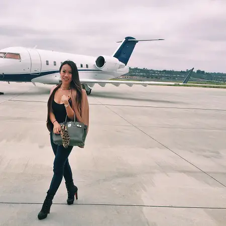 Kelly Mi Li in front of her private jet.