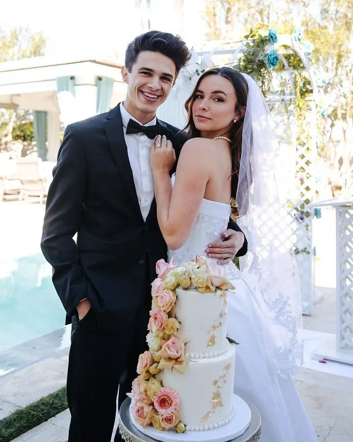 Brent Rivera (Left) and Pierson Wodzynski (Right) posing for their pretend-wedding in behind the cake.