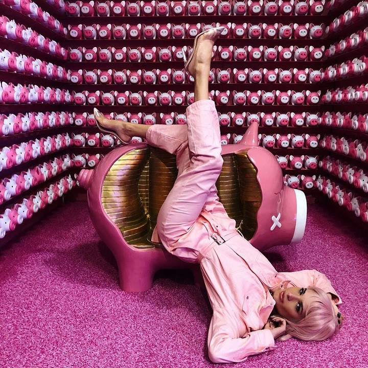 Ava Marie Capra laying upside down a couch with a look like 'Ashley O' from a 'Black Mirror' episode.