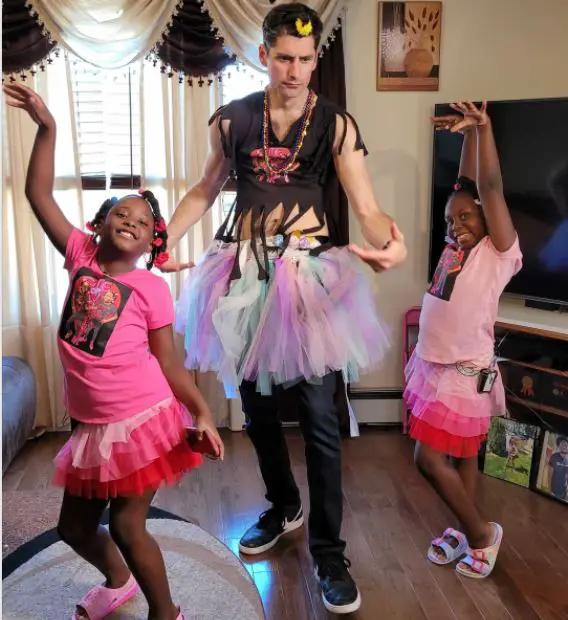 Ben Aaron (Center) in a costume made for girls by two eight-year-old entrepreneurs Mia and Tamia.