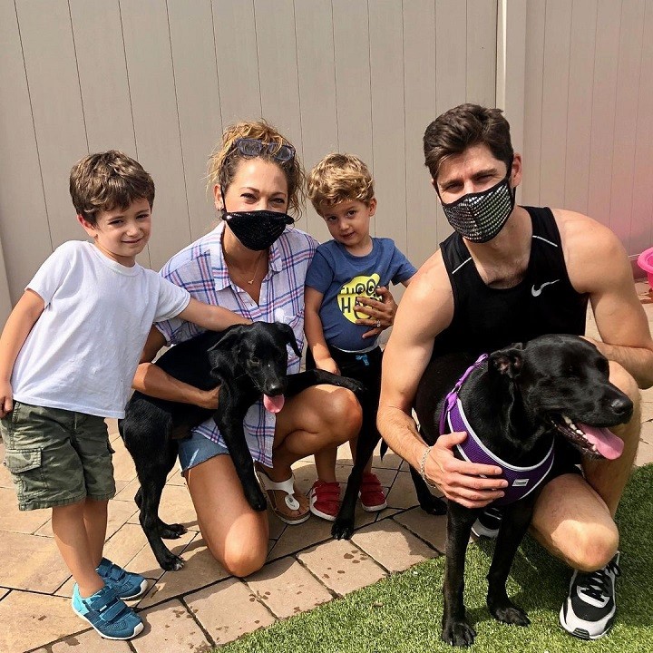 Ginger Zee (second from left) and Ben Aaron (far right) with their two sons and two dogs.