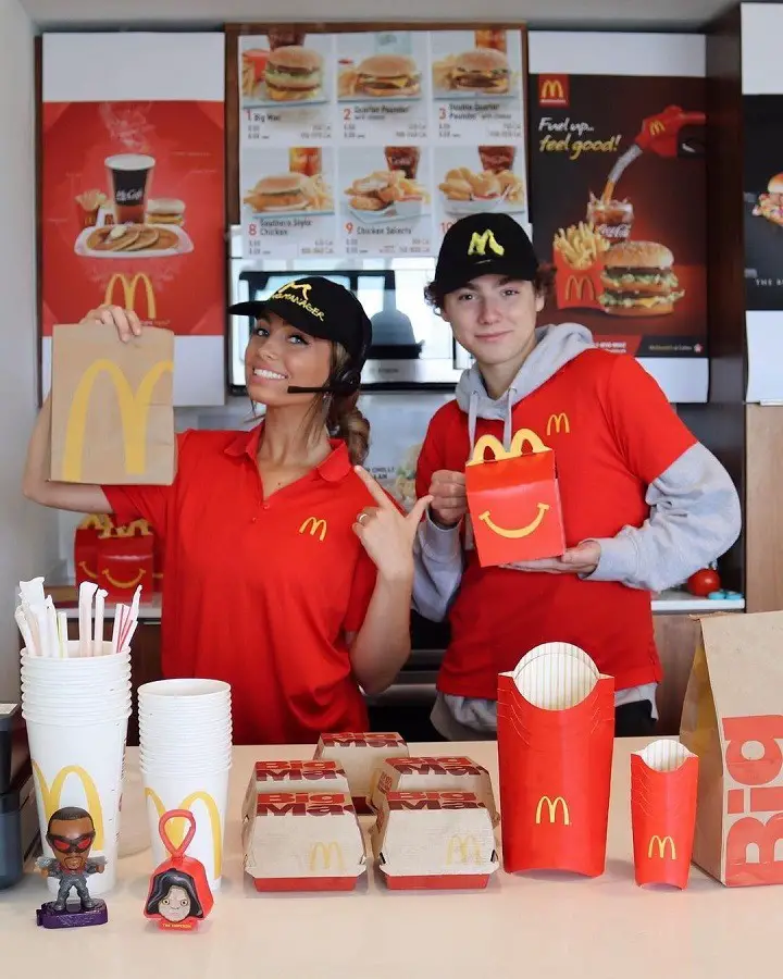 Lexi Hensler (left) and Paris Rosenbaum operating her fake McDonald's at her house for a video.