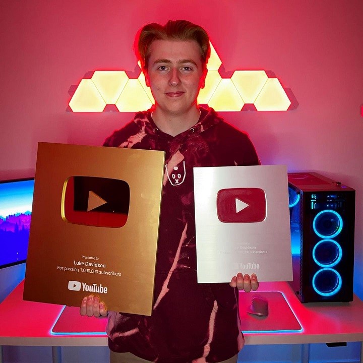 Luke Davidson holding the Golden 1 million subscriber plaque from YouTube.