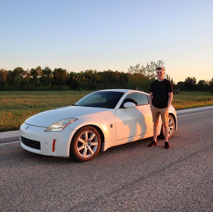 Luke Davidson posing in front of his newly bought dream car, Nissan.