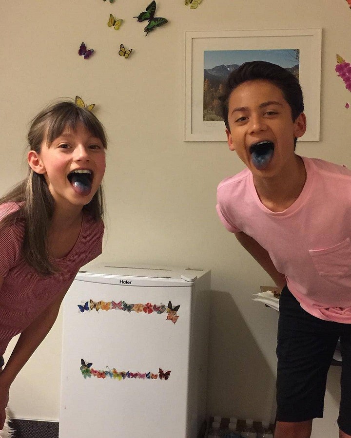 Tenzing Norgay Trainor sticking his blue-colored tongue out with a friend.