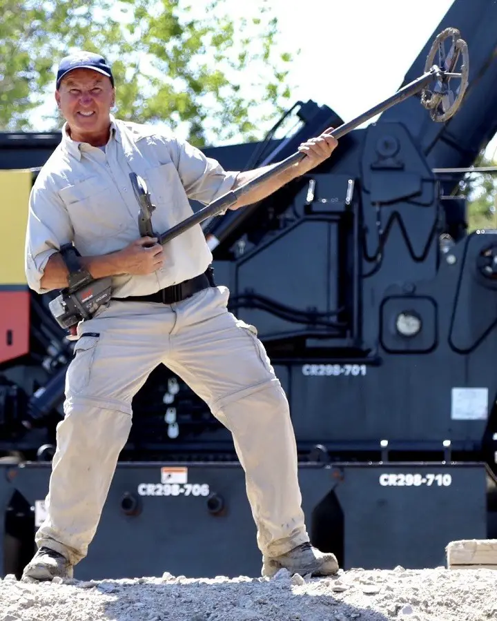 Gary Drayton holding a metal detector as if it's a guitar.