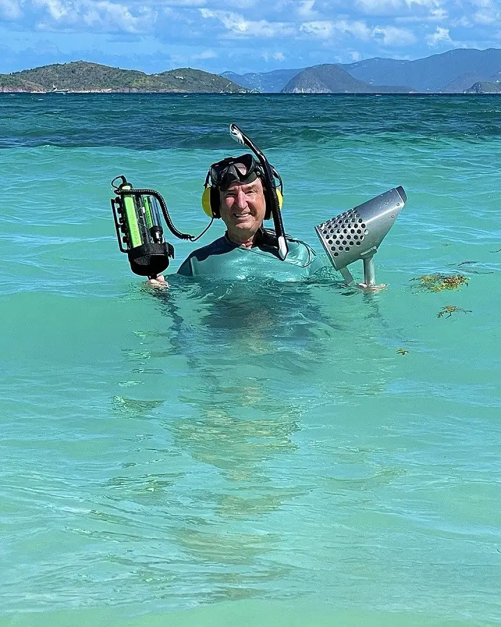Gary Drayton emerging out of the water after an underwater metal detecting stint at the sea.