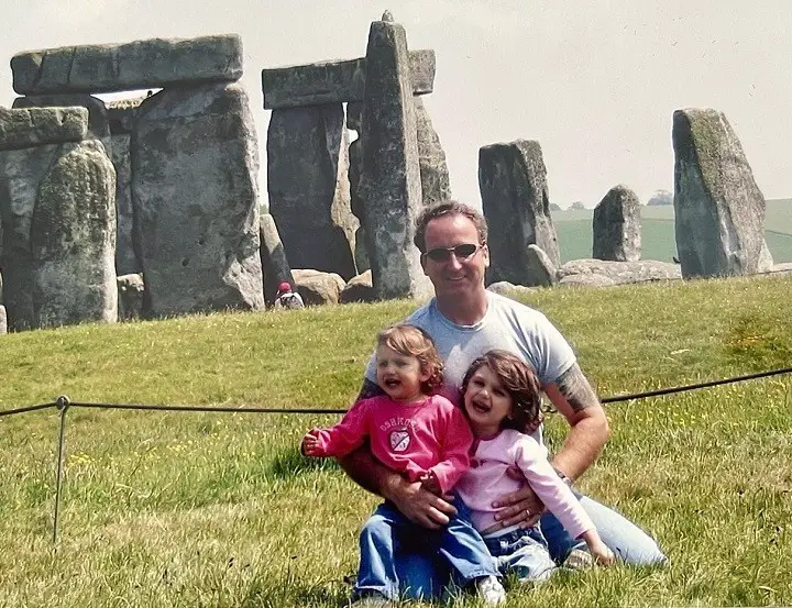 Gary Drayton with his two daughters when young with Stonehenge in the background.