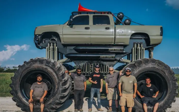 Whistlindiesel (center) with the rest of the crew in front of a custom-made monster truck.