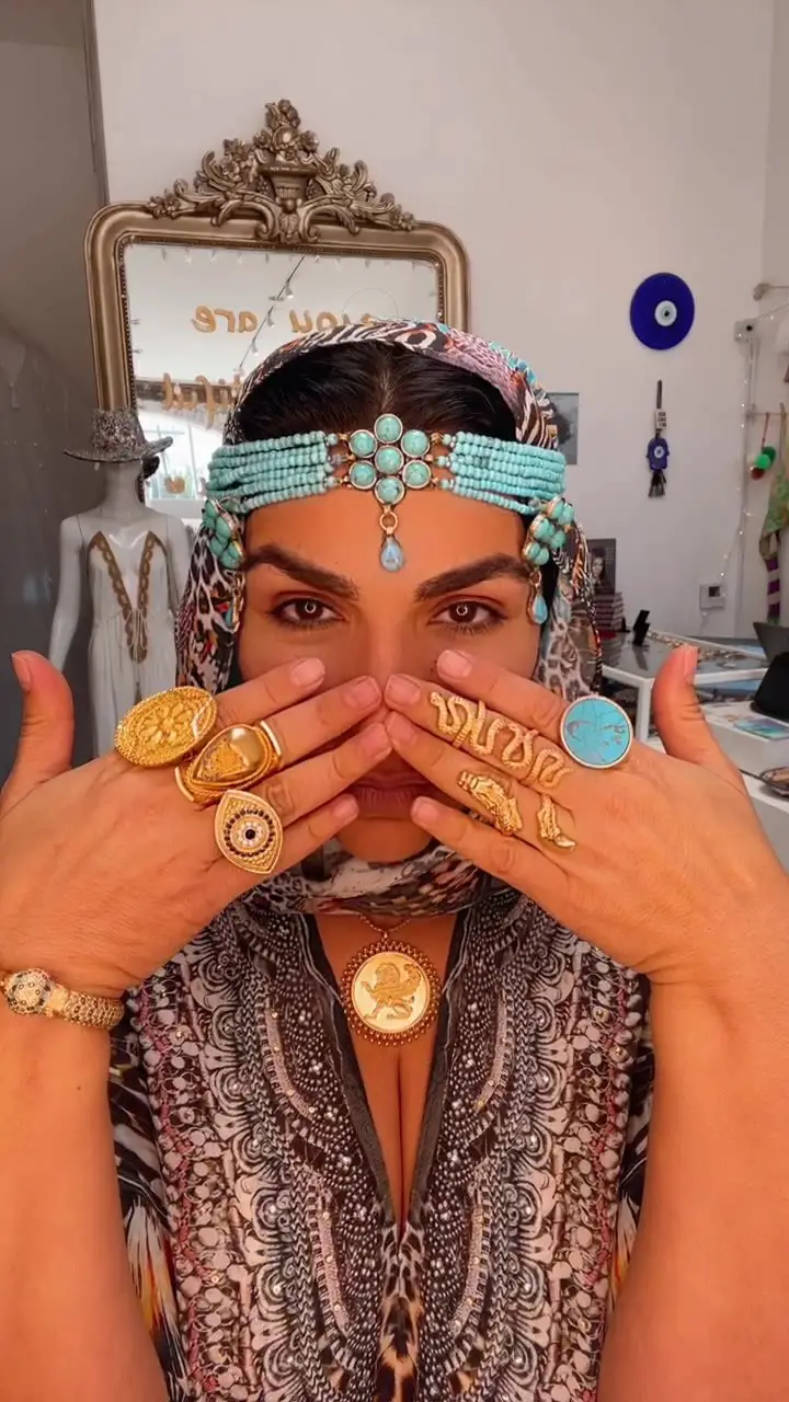 Asa Soltan Rahmati showcasing her products in her hand and her head.