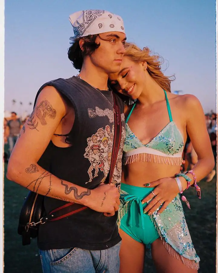 Emma Brooks McAllister (right) leaning on to her boyfriend Zack Lugo (left) both not looking at the camera at Coachella 2022 in April.