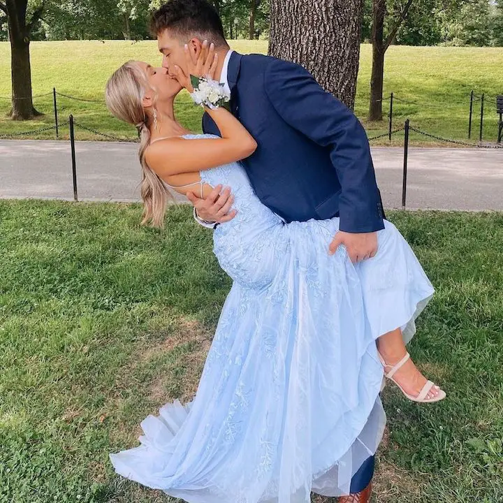 Katie Feeney (left) being kissed by her ex-boyfriend Sean Yamana (right) when they were dating for prom as he lifts one of her legs and leans over to kiss her.