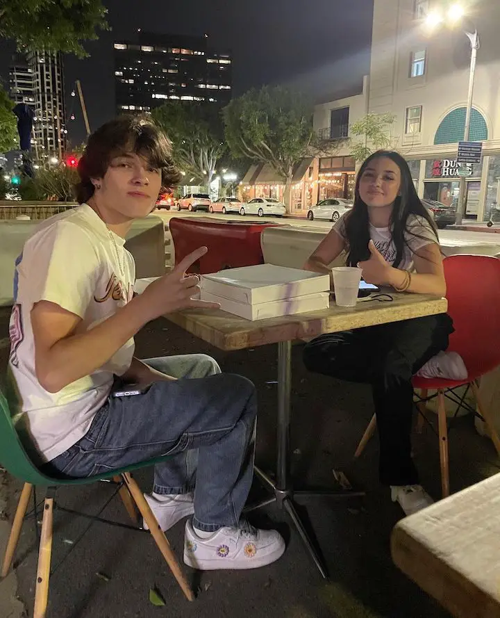 Madi Filipowicz (right) sitting across the table from Christopher or Chris Sturniolo during dinner.