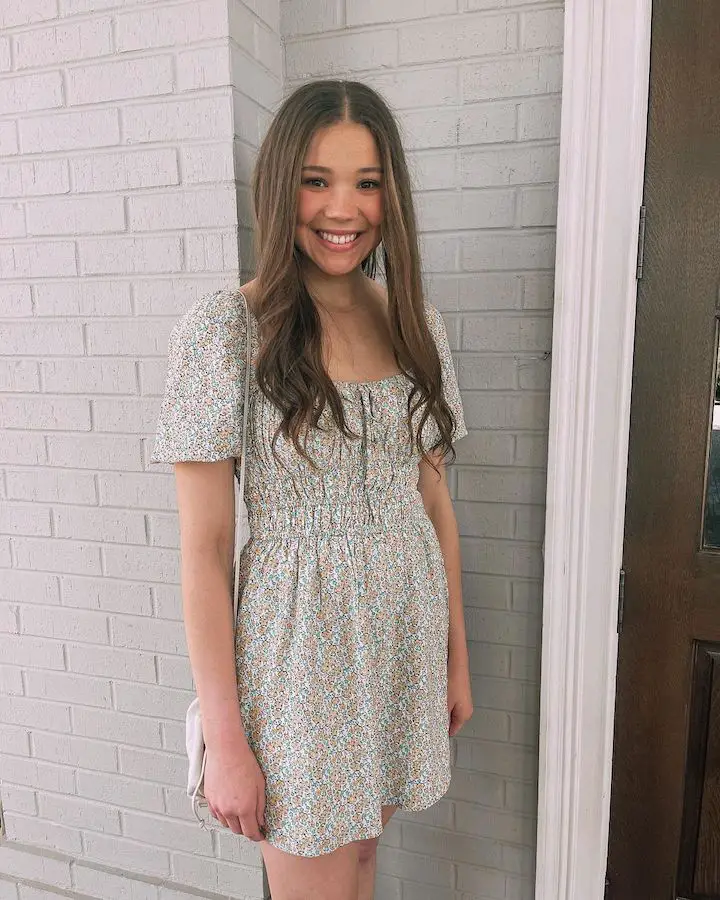 Madison Haschak in a pattern dress with straight hair.
