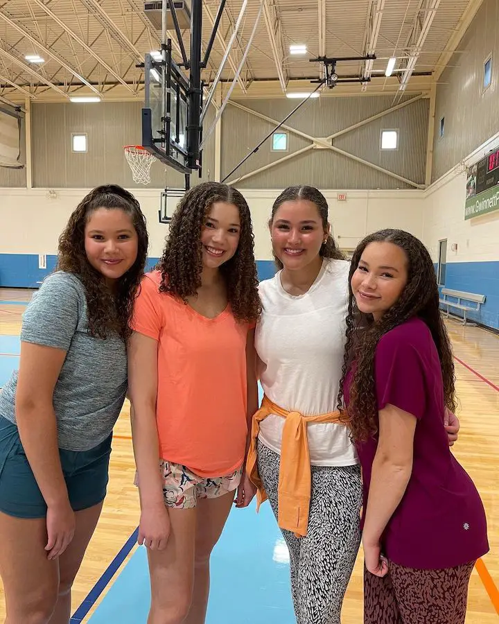 (L-R) The Haschak Sisters, Sierra Haschak, Madison Haschak, Gracie Haschak and Olivia Haschak posing while on a basketball pitch.