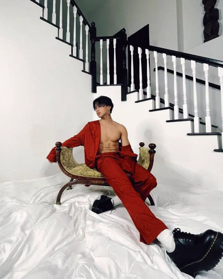 Regie Macalino posing for a photo in red suit.
